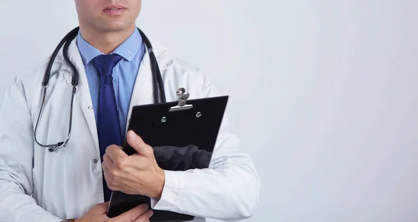 Male doctor standing with folder, isolated on white background — Stock Photo, Image