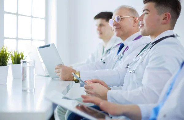 Medical team sitting and discussing at table — Stock Photo, Image