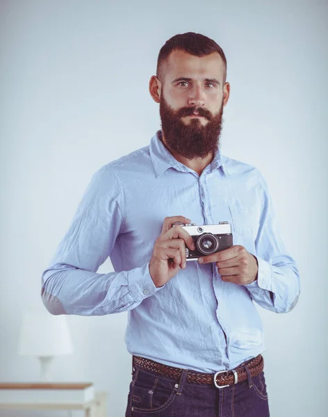 Portrait of a handsome young man holding a camera — Stock Photo, Image