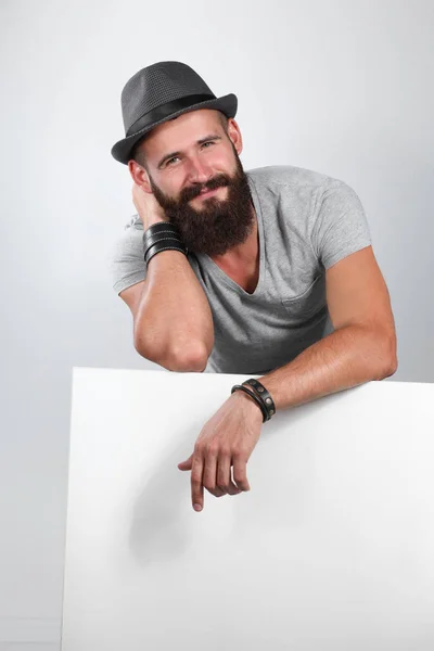 Young man leaning on the empty board — Stock Photo, Image