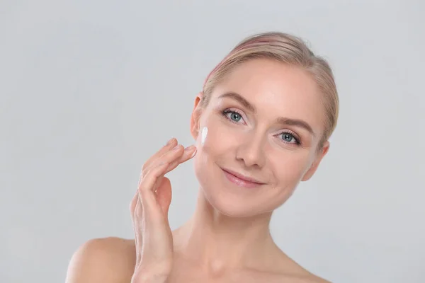 The beautiful young girl with a clean fresh skin touches with a hand a cheek — Stock Photo, Image