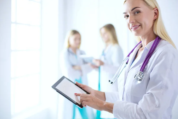 Portrait of a young female doctor, with aipads in hand, in a medical office — Stock Photo, Image