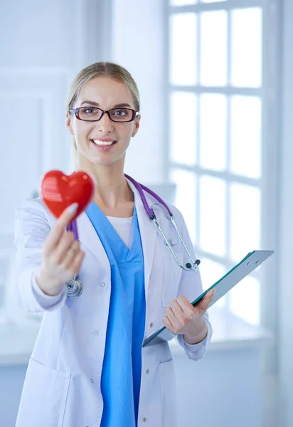 Жінка-лікар зі стетоскопом тримає серце — стокове фото