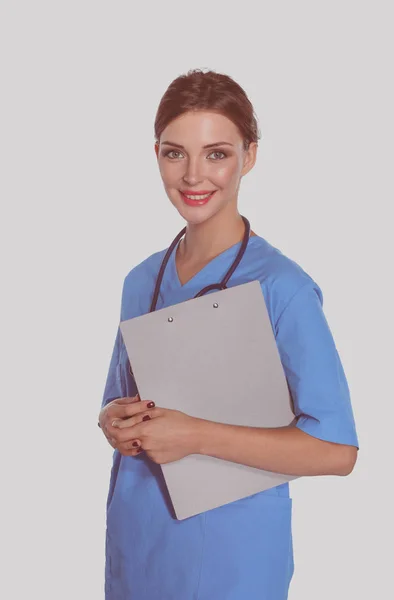 Μια γυναίκα γιατρός με ένα φάκελο, στέκεται απομονωμένη σε λευκό φόντο — Φωτογραφία Αρχείου