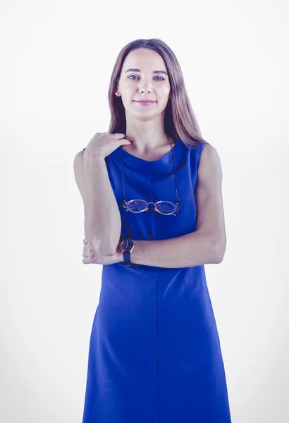 Smiling woman in dress with her arms folded against white background — Stock Photo, Image