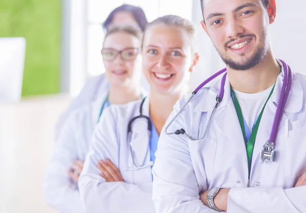 Happy medical team comprising male and female doctors smiling broadly and giving a thumbs up of success and hope — Stock Photo, Image