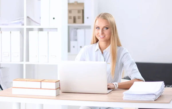 Retrato de recepcionista sorridente usando computador portátil e fone de ouvido na mesa de escritório — Fotografia de Stock