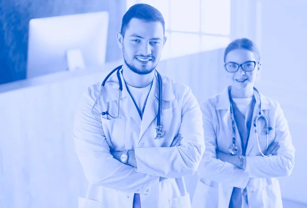 A medical team of doctors, man and woman, isolated on white background — Stock Photo, Image