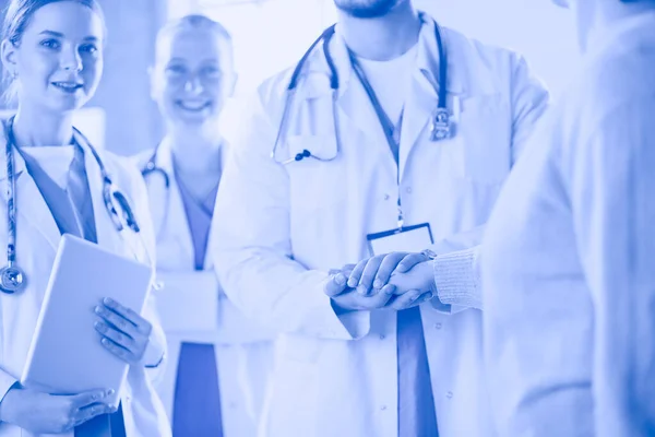 Doctors and nurses stacking hands. Isolated on white — Stock Photo, Image