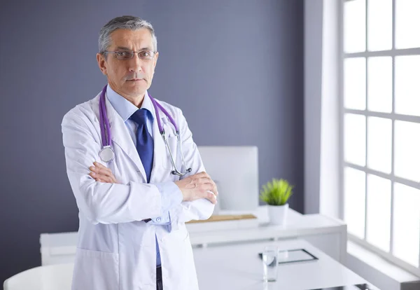 Porträtt av en leende läkare på hans ljusa kontor — Stockfoto