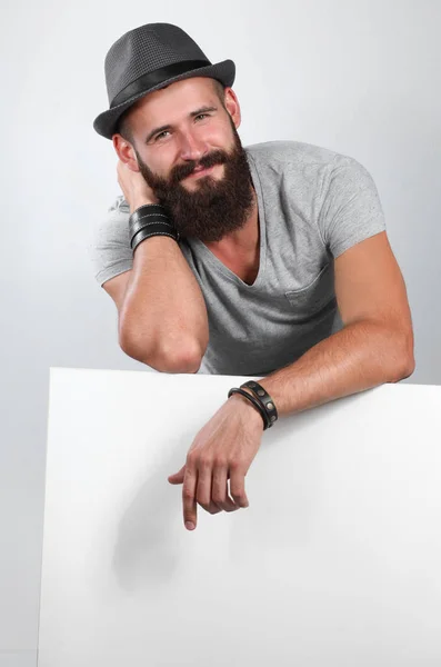 Young man leaning on the empty board — Stock Photo, Image