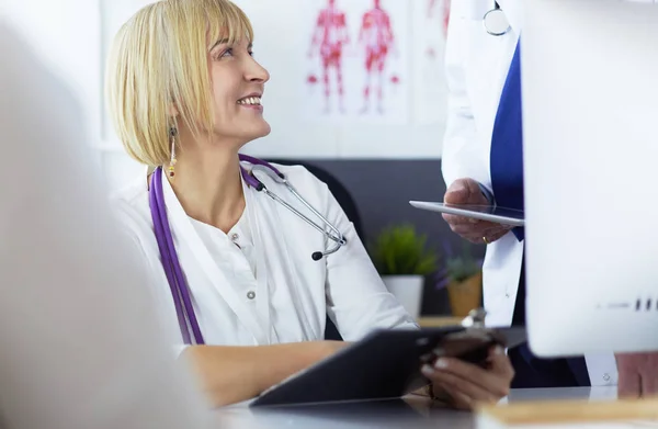 Female doctor sitting at table with laptop, working — 스톡 사진