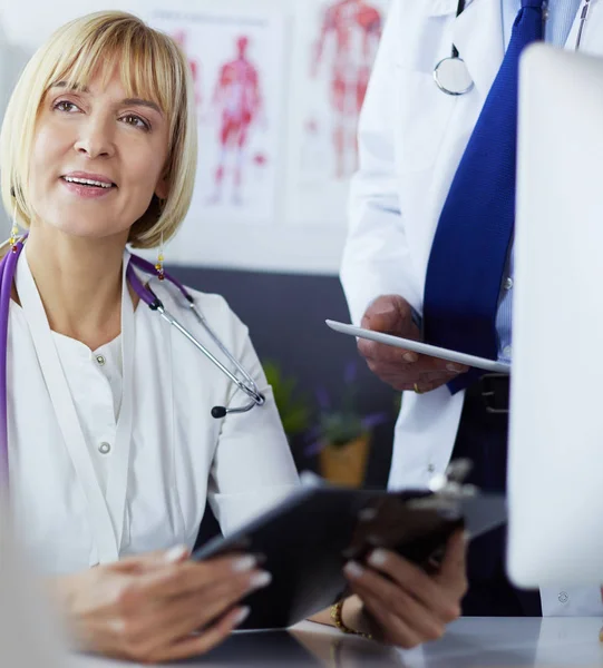 Doctor and nurse working in office at hospital — 스톡 사진