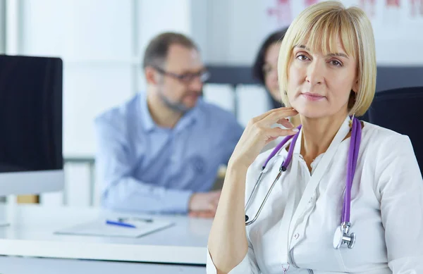 stock image Doctor woman sitting with male patient at the desk