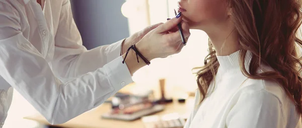 Beautiful young model woman getting fashion make-up — 스톡 사진