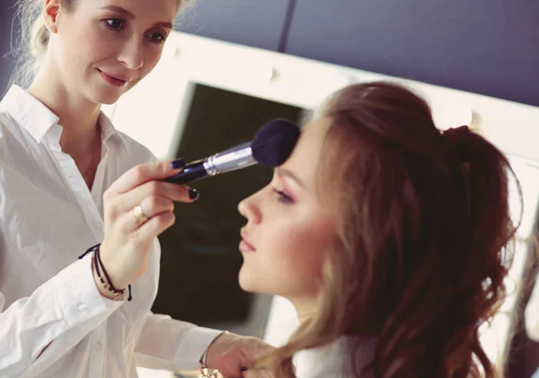 Beautiful young model woman getting fashion make-up — Stock Photo, Image