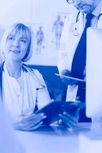 Doctor and nurse working in office at hospital — Stock Photo, Image