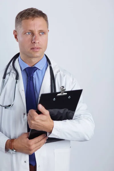 Male doctor standing with folder, isolated on white background — Stock Photo, Image