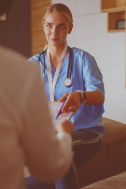 Doktor ve hasta masada otururken bir şey tartışıyorlar. İlaç ve sağlık hizmetleri kavramı