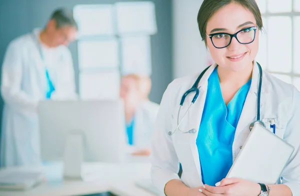 Female doctor using tablet computer in hospital lobby