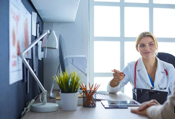 Female doctor holding application form while consulting patient