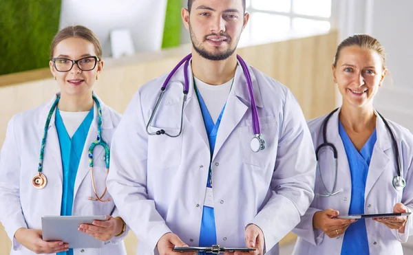 Attractive young doctor with his young colleagues — Stock Photo, Image