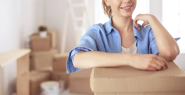 Portrait of a young woman with boxes — Stock Photo, Image