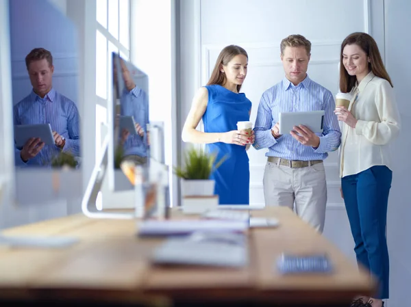 Happy businesspeople using digital tablet outside office building — 스톡 사진