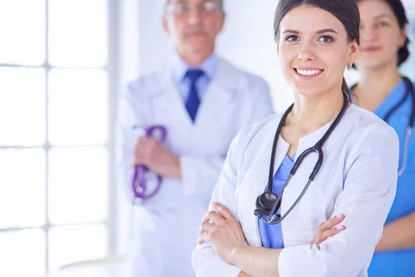 Group of doctors and nurses standing in a hospital room — Stock Photo, Image