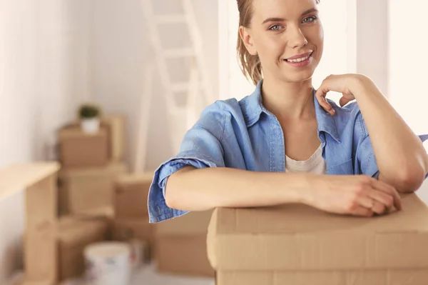 Portrait of a young woman with boxes — Stock Photo, Image