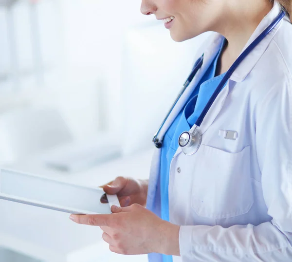 Médico femenino usando tableta en el vestíbulo del hospital —  Fotos de Stock