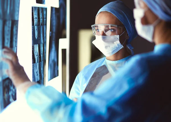 Two female women medical doctors looking at x-rays in a hospital — Stock Photo, Image