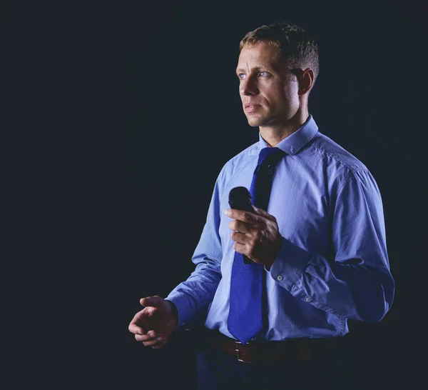 Businessman speech concept, talking with microphone in conference hall — Stock Photo, Image