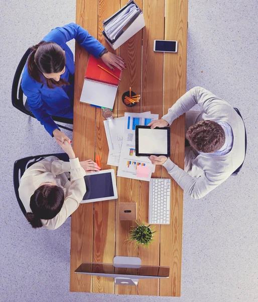 Young business people sitting at desk working together using laptop computer — Stock Photo, Image