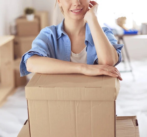 Portrait of a young woman with boxes — Stock Photo, Image