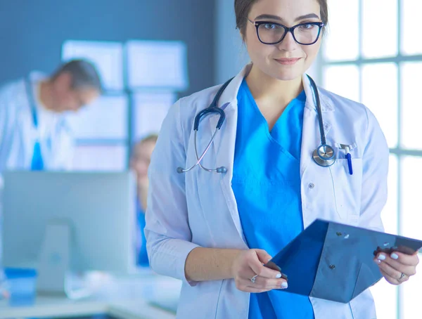 Female doctor using tablet computer in hospital lobby