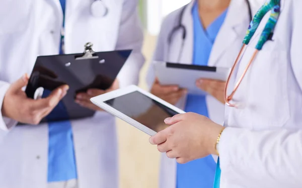 Ärzte mit Tablette im Krankenhaus im Stehen — Stockfoto