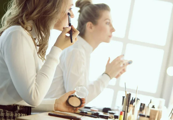 Make up artist doing professional make up of young woman — Stock Photo, Image