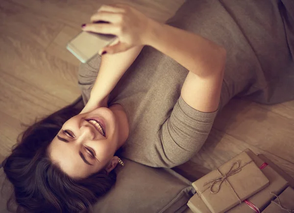 Visão superior de uma mulher usando seu telefone enquanto deitada de costas — Fotografia de Stock