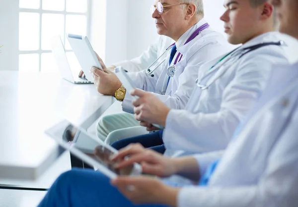 Medical team sitting and discussing at table — Stock Photo, Image