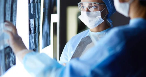 Two female women medical doctors looking at x-rays in a hospital — Stock Photo, Image