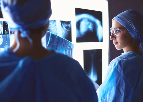 Two female women medical doctors looking at x-rays in a hospital — Stock Photo, Image