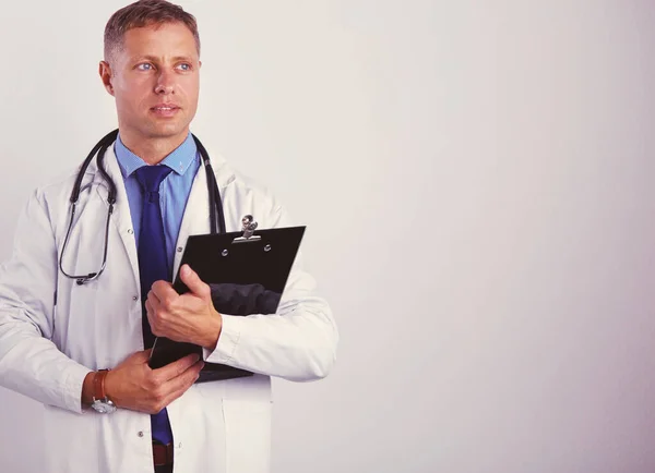 Male doctor standing with folder, isolated on white background — Stock Photo, Image