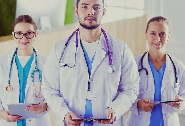 Attractive young doctor with his young colleagues — Stock Photo, Image