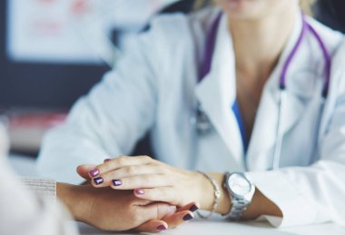Kadın doktor yaşlılara hastanede el ele tutuşmalarında yardım ediyor