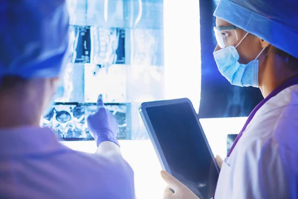 Two female women medical doctors looking at x-rays in a hospital — Stock Photo, Image