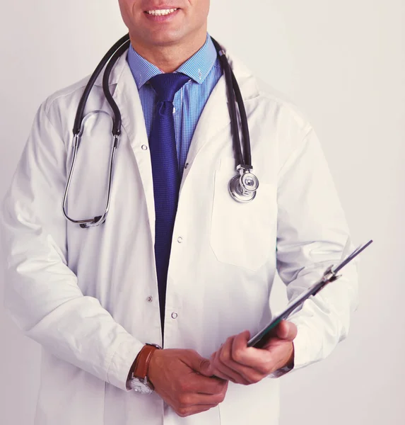 Male doctor standing with folder, isolated on white background — Stock Photo, Image