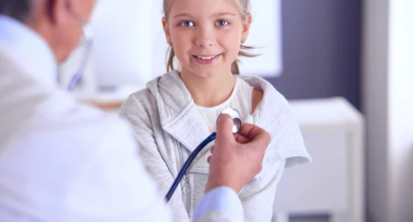 Girl and doctor with stethoscope listening to heartbeat — Stock Photo, Image