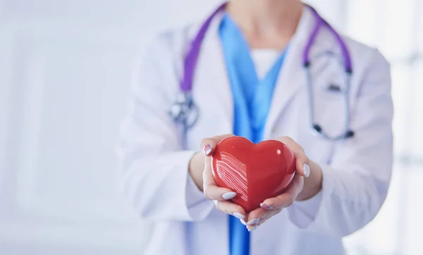 Doctor with stethoscope holding heart, isolated on white background — Stock Photo, Image