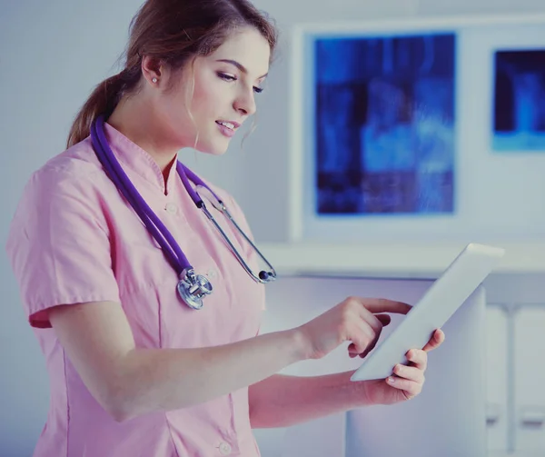 Doctor woman checking medical data on tablet pc